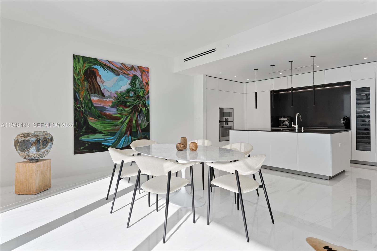 300 Biscayne Blvd Way, Unit 2102 Miami, FL 33131 - Photo 20 of 80 a view of a dining room with furniture and a flat screen tv