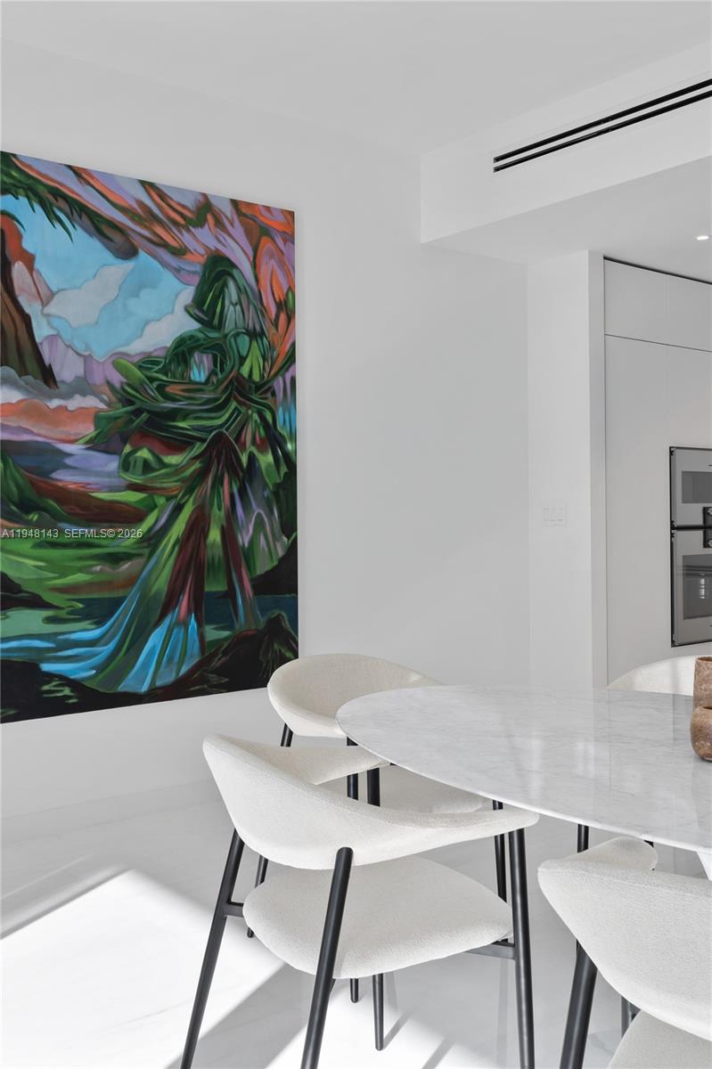 300 Biscayne Blvd Way, Unit 2102 Miami, FL 33131 - Photo 22 of 80 a view of a workspace with a table and chair in a patio