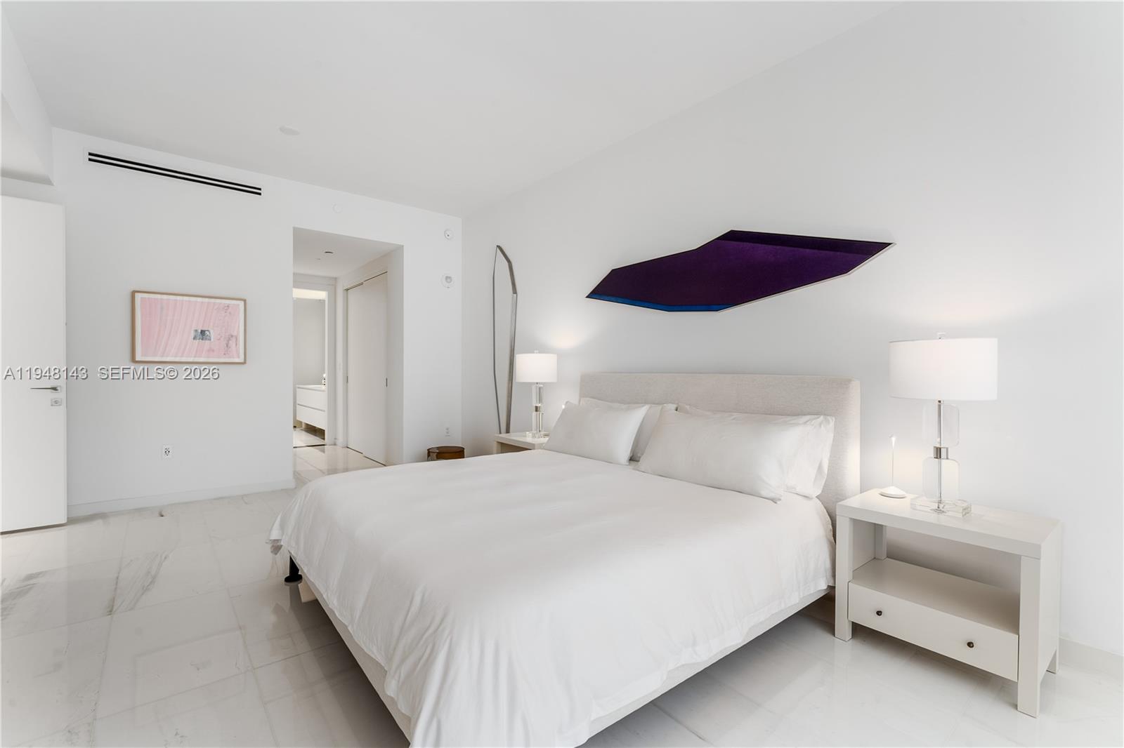 300 Biscayne Blvd Way, Unit 2102 Miami, FL 33131 - Photo 43 of 80 a bedroom with a bed and a lamp