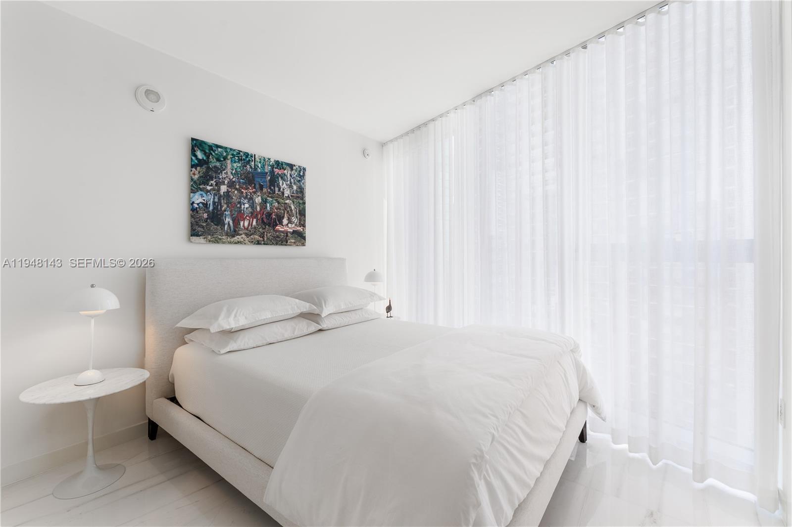 300 Biscayne Blvd Way, Unit 2102 Miami, FL 33131 - Photo 51 of 80 a bedroom with a bed and a painting on the wall