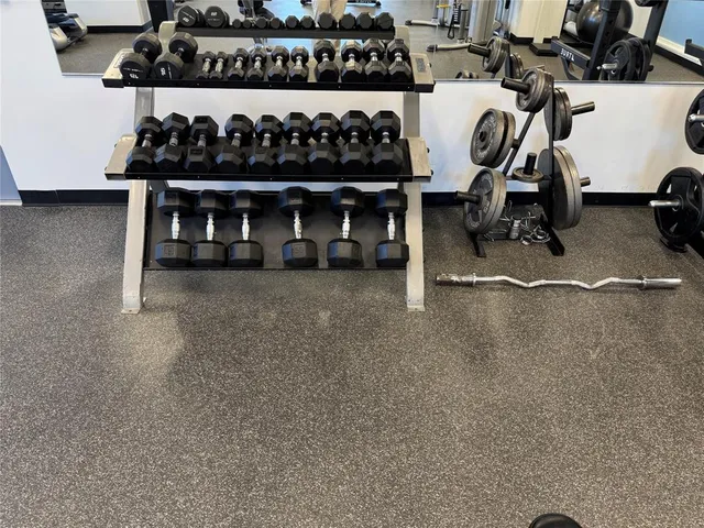a living room with furniture and a mirror