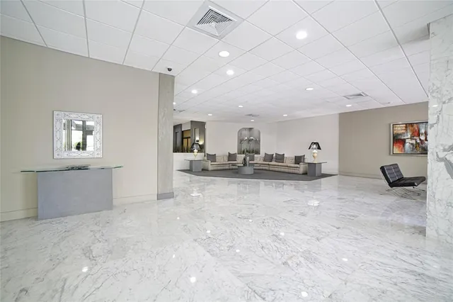 a living room with furniture a table tennis pool table and chairs