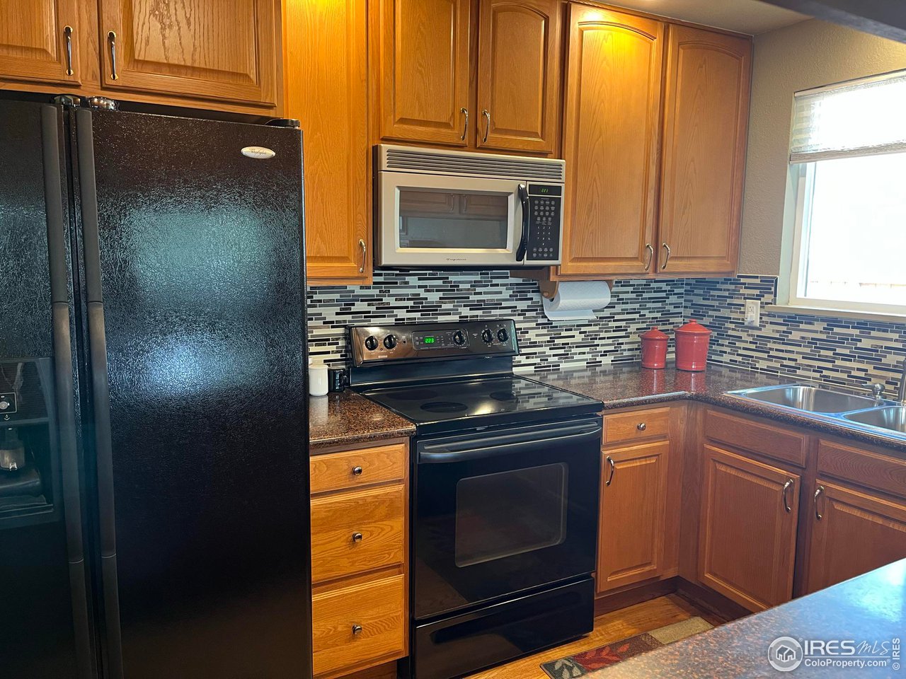 7760 Durham Way Boulder, CO 80301 - Photo 11 of 33 a kitchen with stainless steel appliances granite countertop a sink stove and microwave