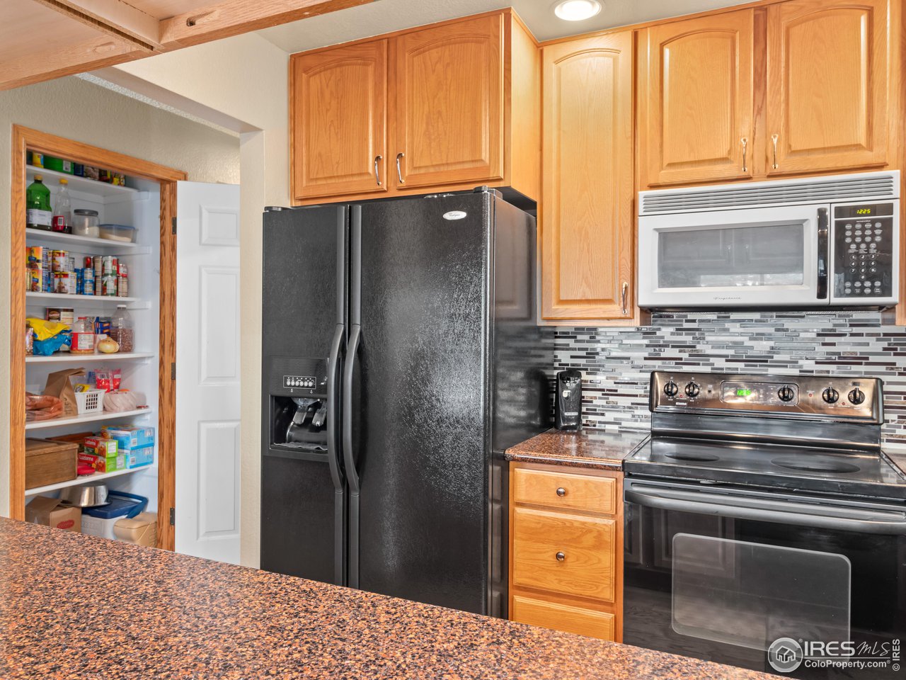 7760 Durham Way Boulder, CO 80301 - Photo 13 of 33 a kitchen with stainless steel appliances granite countertop a refrigerator and a stove top oven