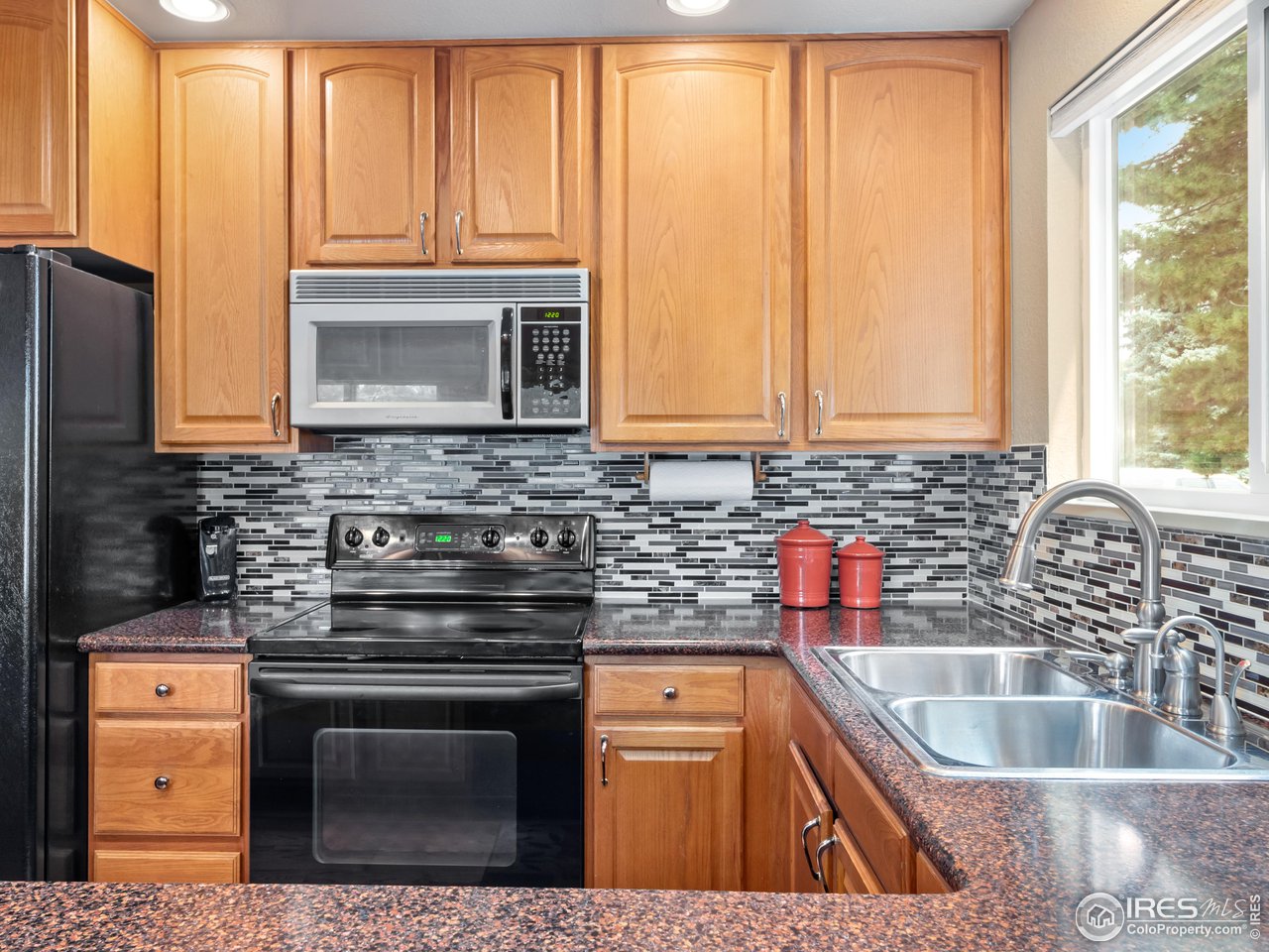 7760 Durham Way Boulder, CO 80301 - Photo 14 of 33 a kitchen with stainless steel appliances granite countertop a sink stove and microwave