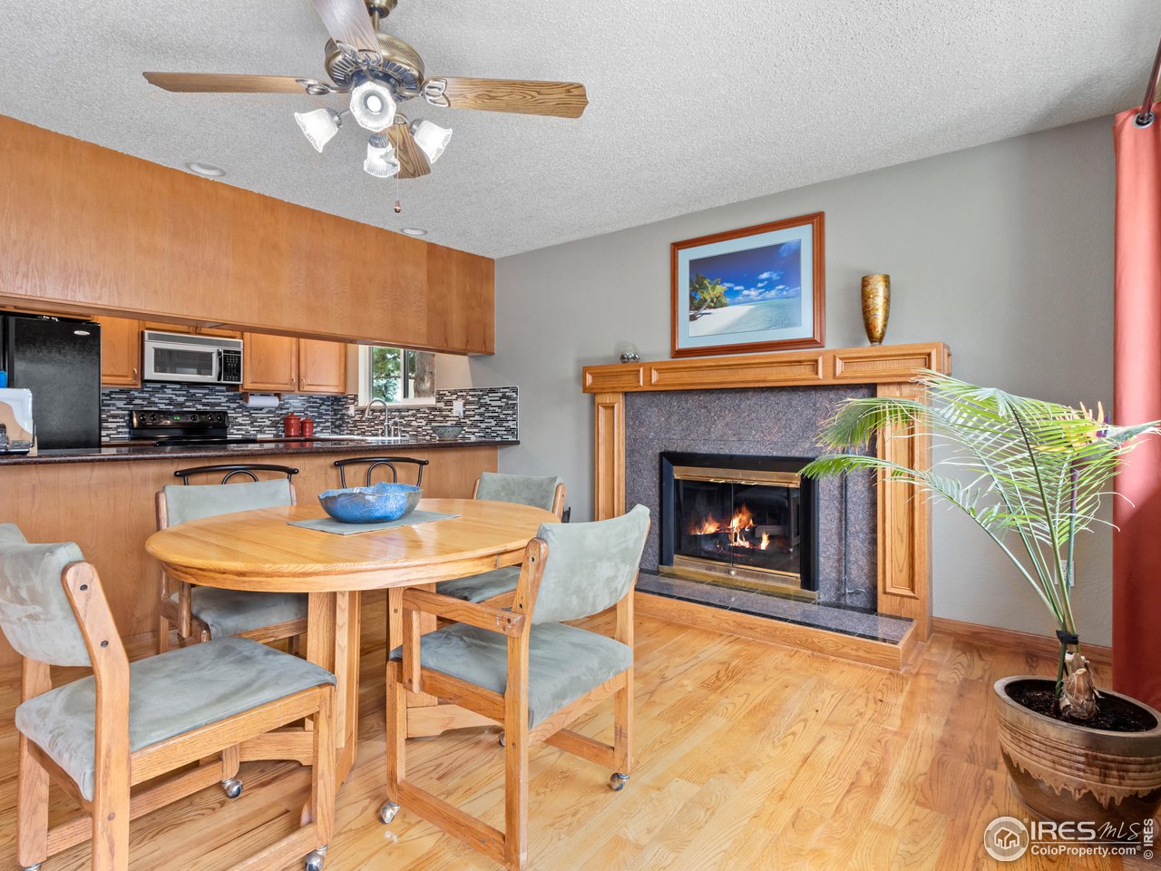 7760 Durham Way Boulder, CO 80301 - Photo 15 of 33 a living room with a fireplace a dining table and a fireplace