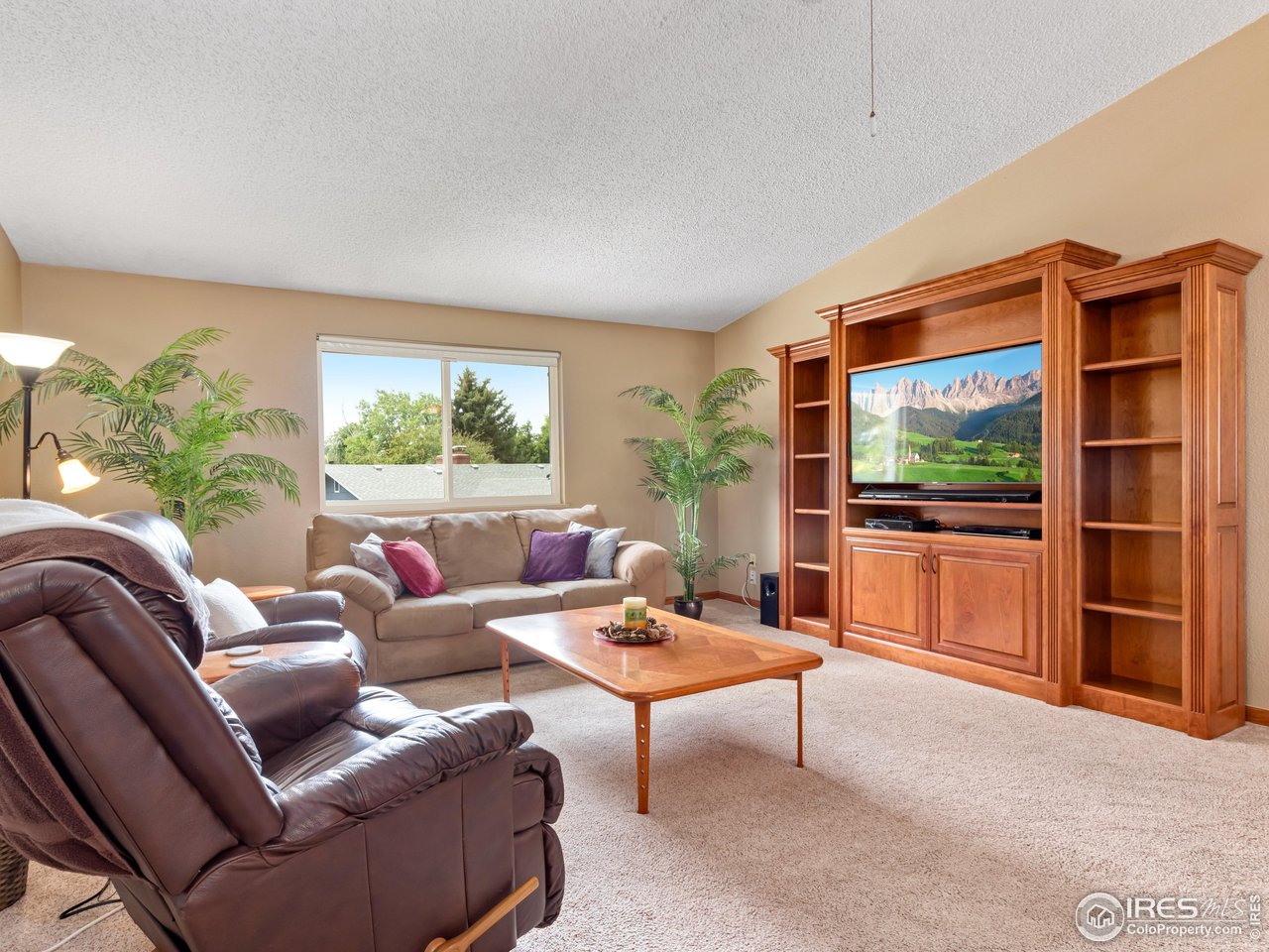 7760 Durham Way Boulder, CO 80301 - Photo 19 of 33 a living room with furniture a window and a flat screen tv