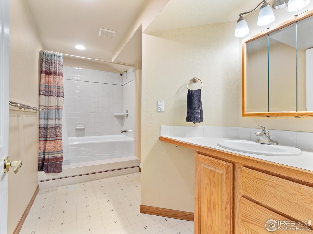 7760 Durham Way Boulder, CO 80301 - Photo 30 of 33 a bathroom with a granite countertop sink and a mirror
