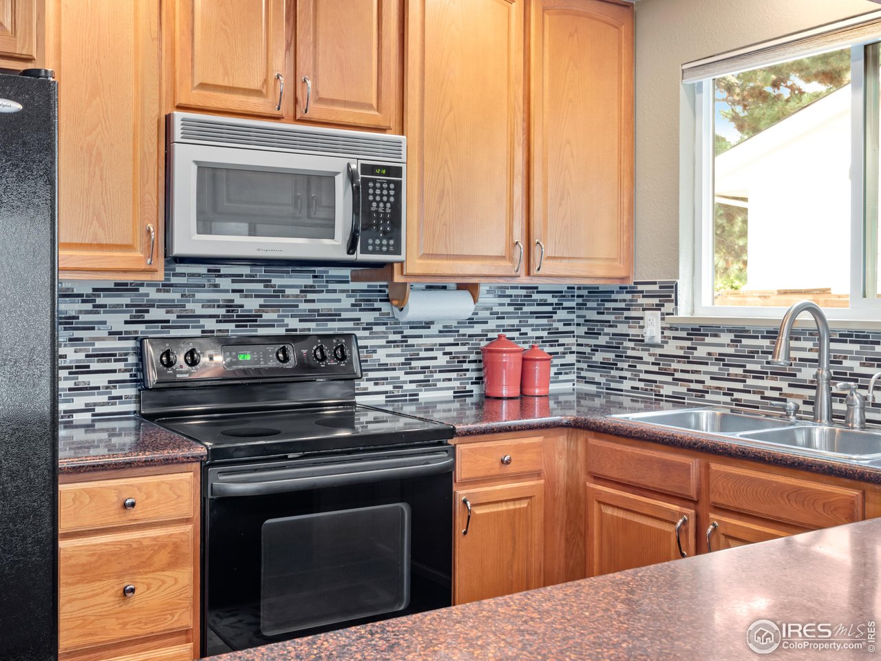 7760 Durham Way Boulder, CO 80301 - Photo 10 of 33 a kitchen with granite countertop a sink stove and microwave