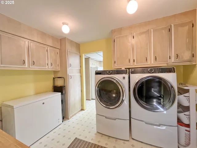 a utility room with sink dryer and washer