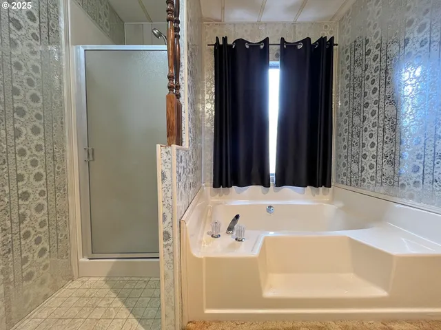 a bathroom with bathtub and shower