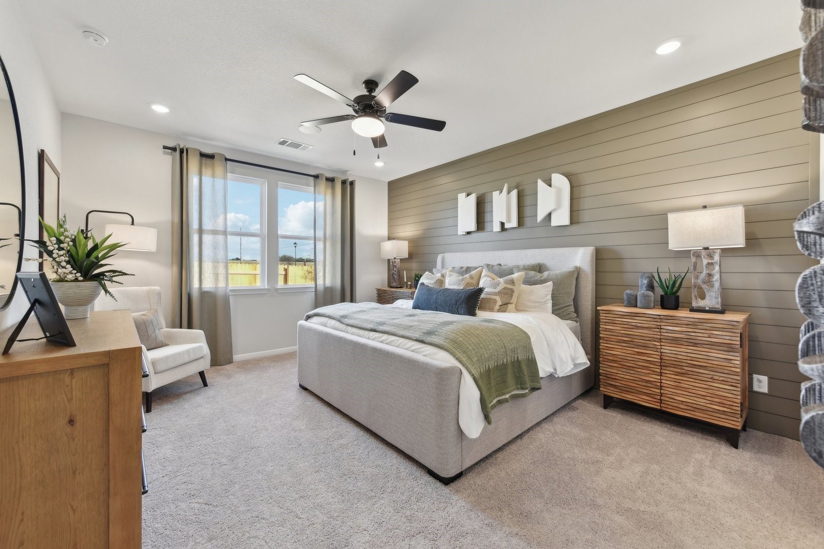 216 Firefox Way Jarrell, TX 76537 - Photo 10 of 17 Plush carpeting and custom wall paneling create a comfortable atmosphere in this inviting bedroom.