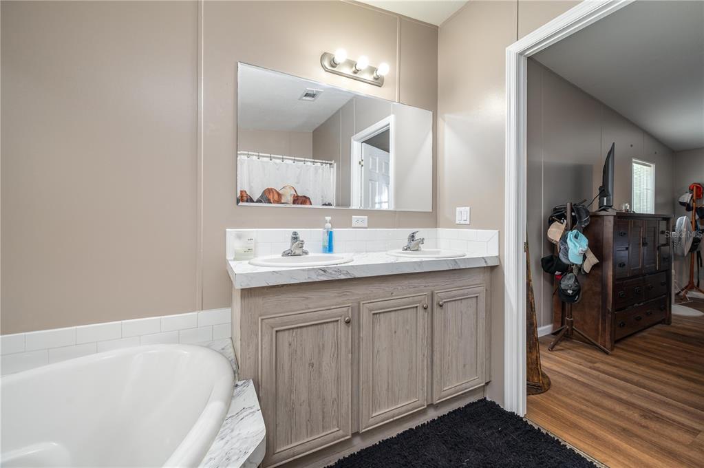 15079 Brahma Road Polk City, FL 33868 - Photo 9 of 40 a bathroom with a sink double vanity and a bathtub