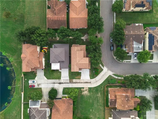an aerial view of a house with outdoor space and lake view