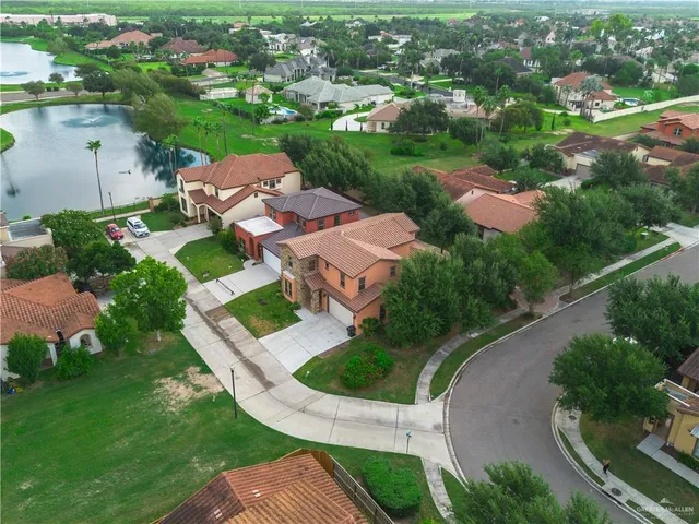 an aerial view of a house with outdoor space pool lake and outdoor seating