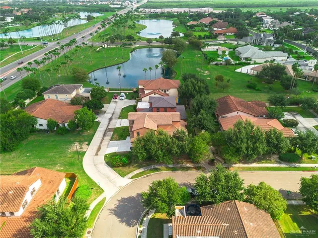 an aerial view of residential houses with outdoor space and street view