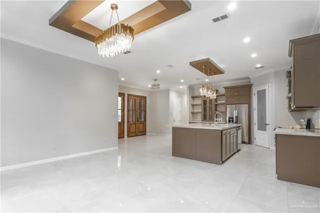 a large kitchen with a refrigerator and a stove top oven