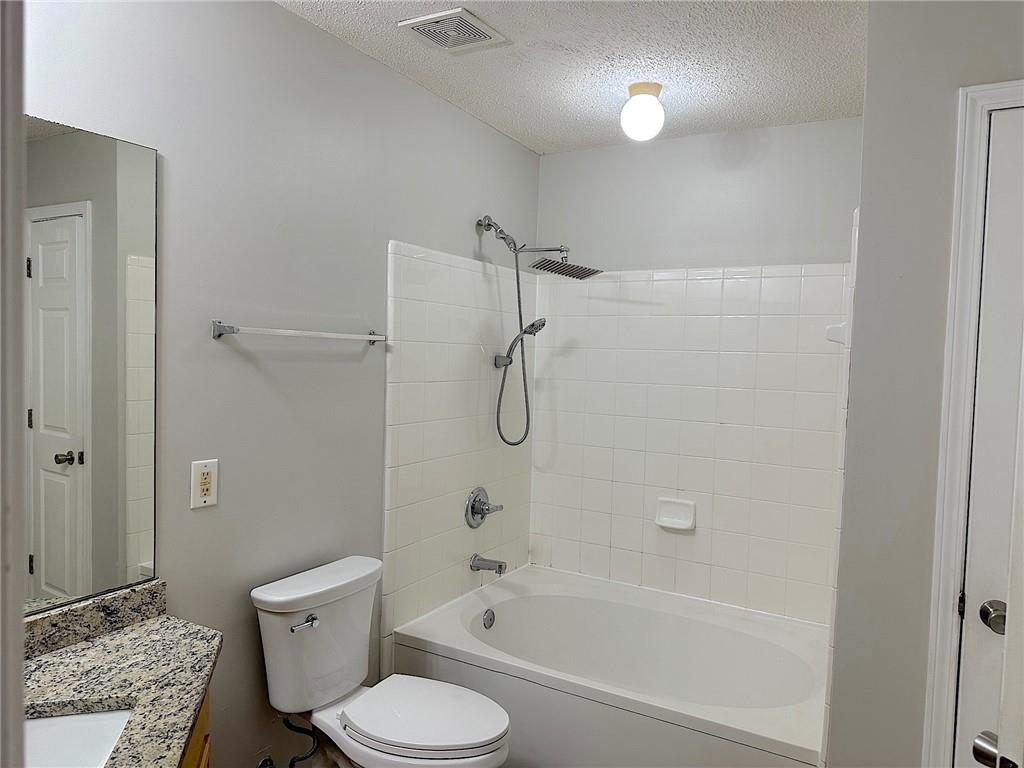 245 Amal Drive Southwest, Unit 2008 Atlanta, GA 30315 - Photo 13 of 23 a bathroom with a shower a toilet and a shower