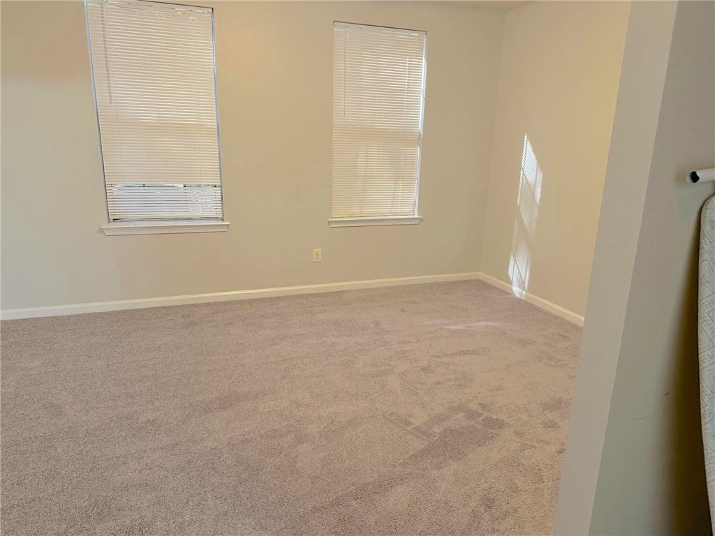 245 Amal Drive Southwest, Unit 2008 Atlanta, GA 30315 - Photo 17 of 23 an empty room with windows and closet
