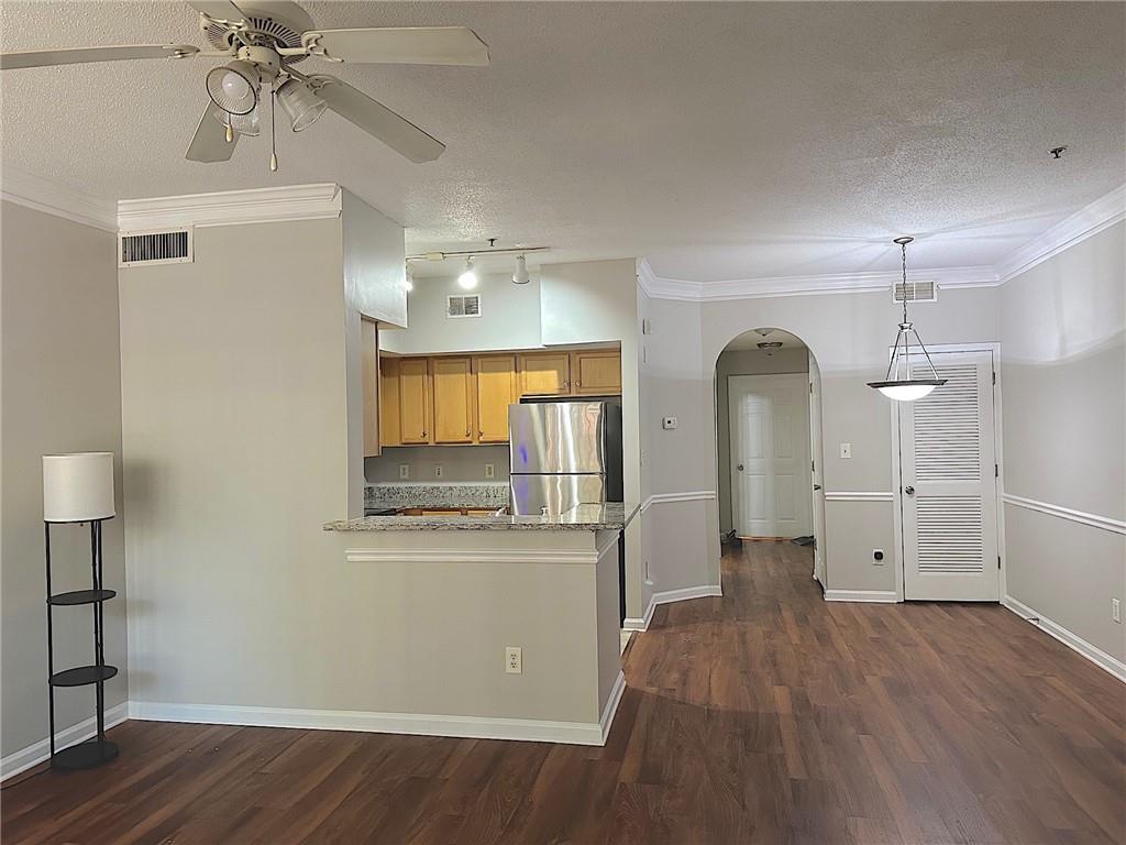 245 Amal Drive Southwest, Unit 2008 Atlanta, GA 30315 - Photo 8 of 23 a view of empty room with wooden floor and fan