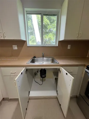 a utility room with sink dryer and washer