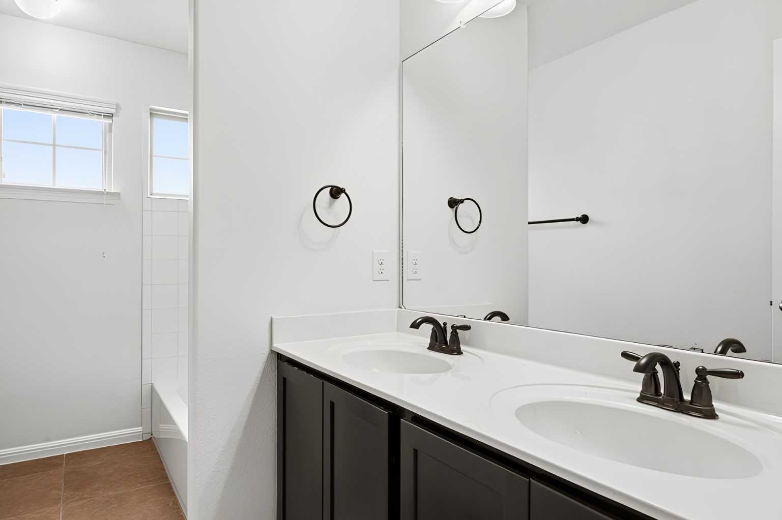 304 Santa Maria Street Georgetown, TX 78628 - Photo 25 of 37 Double vanity with ample counter space and a sleek mirror create a functional and pleasant bathroom.