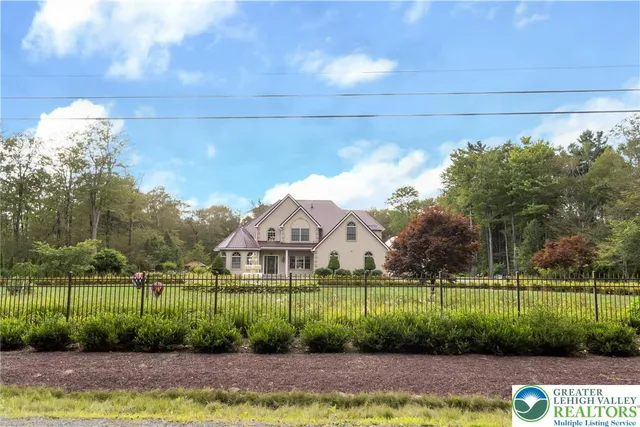 a view of a house with a big yard and potted plants