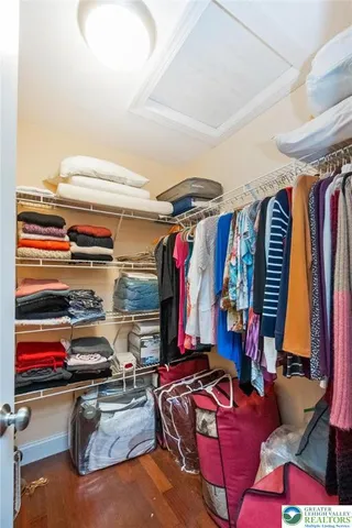 a living room with furniture kitchen and a flat screen tv