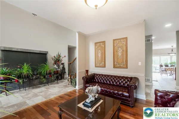 a living room with furniture and flowers