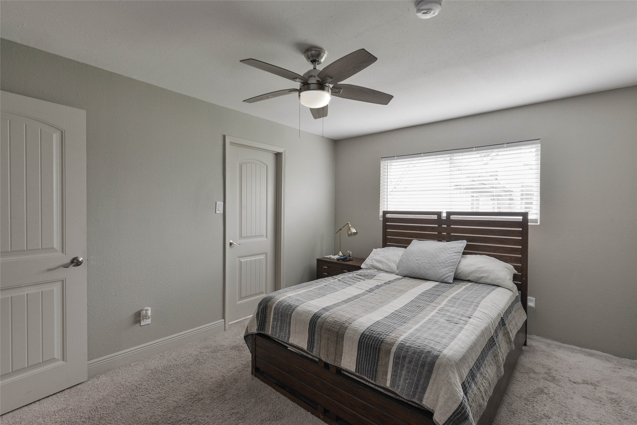 531 Brandon Road Conroe, TX 77302 - Photo 18 of 33 a bedroom with a large bed and a ceiling fan