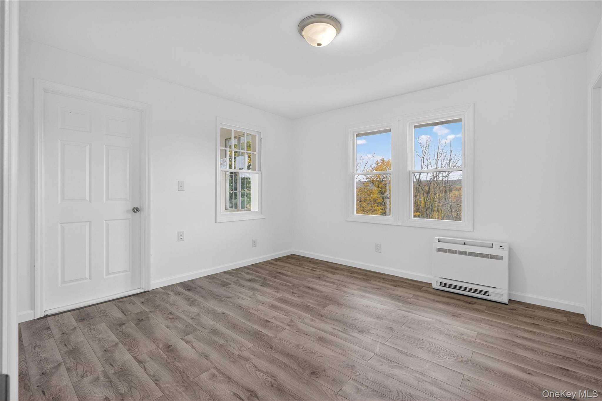 322 Old Rte 22 Pawling, NY 12564 - Photo 11 of 50 an empty room with wooden floor and windows