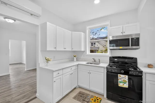 a kitchen with stainless steel appliances a stove a sink and a microwave