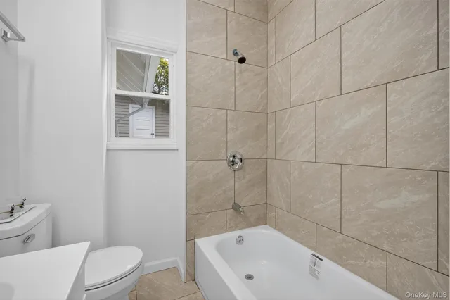 a bathroom with a bathtub and toilet