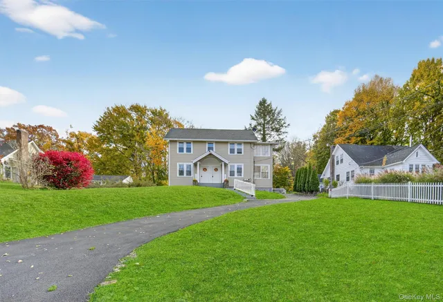 a front view of house with yard and green space