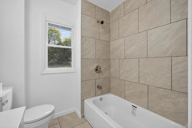 a bathroom with a bathtub and toilet