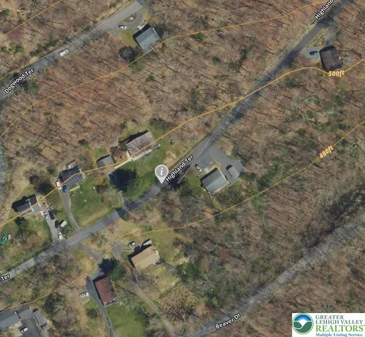 a aerial view of a house with a yard