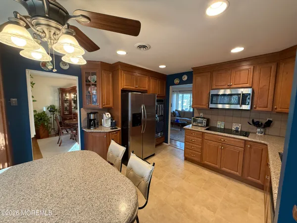 a kitchen with stainless steel appliances granite countertop a sink stove and microwave