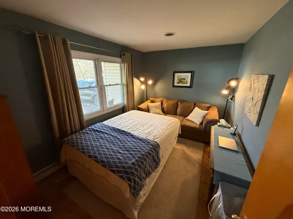 a bedroom with a bed and glass window