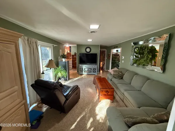 a living room with furniture rug and window