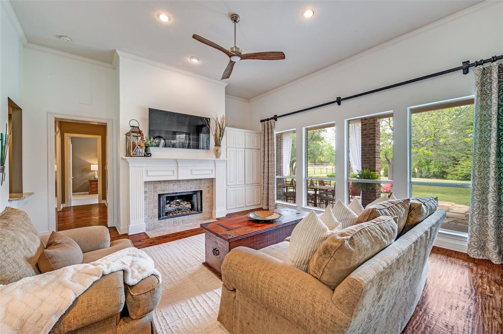 2841 Winding Creek Road Prosper, TX 75078 - Photo 5 of 40 a living room with furniture fireplace and a large window