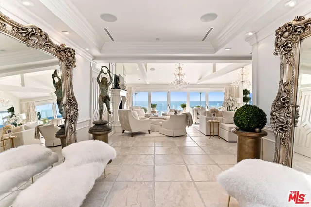 a living room with lots of furniture and a chandelier