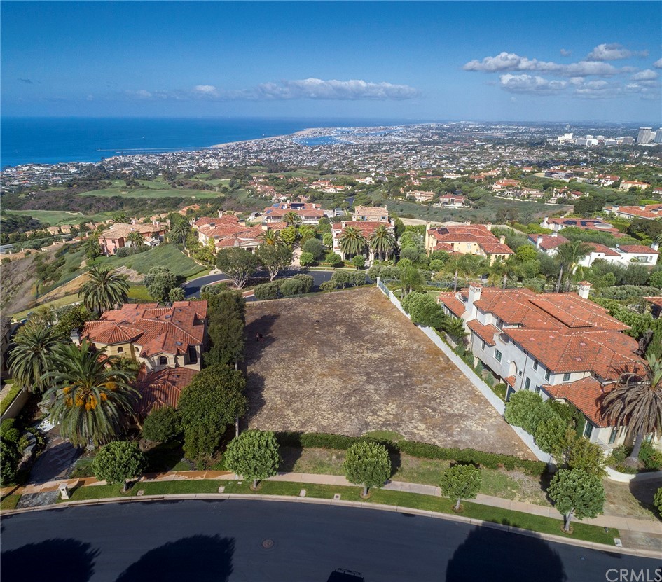 an aerial view of residential houses with outdoor space and street view