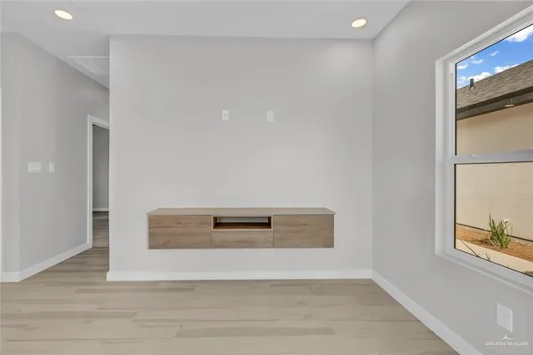 a view of a hallway with wooden floor