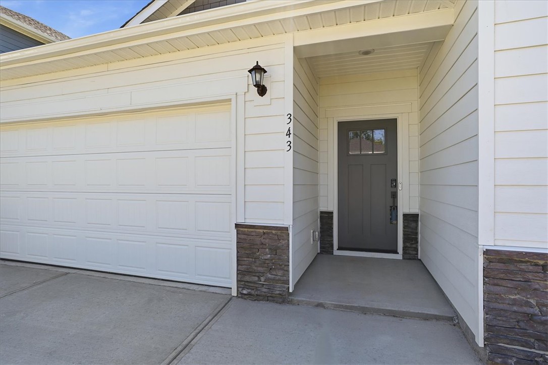 343 Allingham Road Piedmont, SC 29673 - Photo 5 of 37 A welcoming entry, with a paneled garage door and stacked stone accents, greets visitors.
