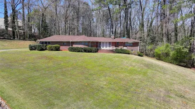 a view of a big yard with an outdoor seating