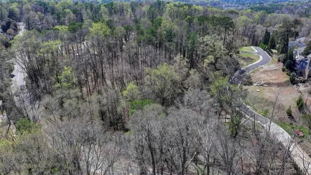 a view of a field of grass and trees