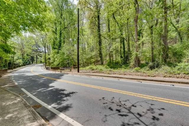 a view of a road with a house in the background