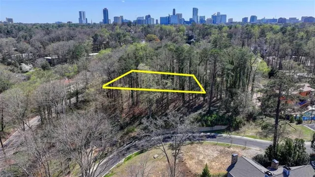 an aerial view of a house with swimming pool and a yard