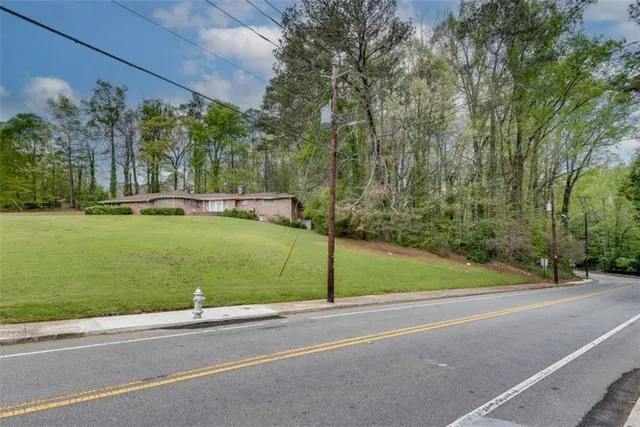 a view of a swimming pool and trees in the background