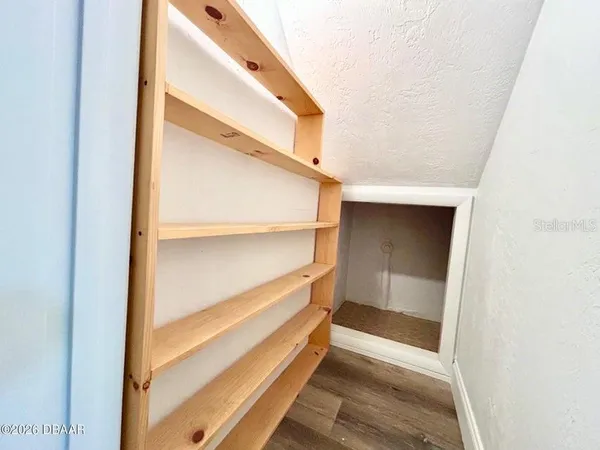 a view of walk in closet with empty room